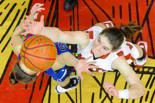 Two Basketball Players Jumping for the Ball