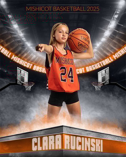 An athlete holding a basketball in her left arm and pointing with her right arm, with a stadium in the background.
